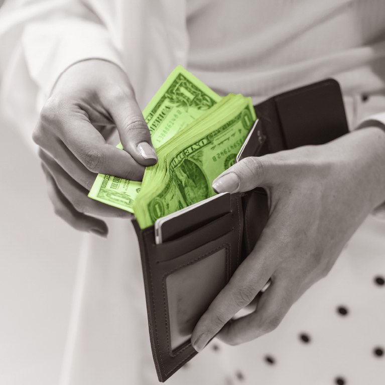 open wallet with dollar bills