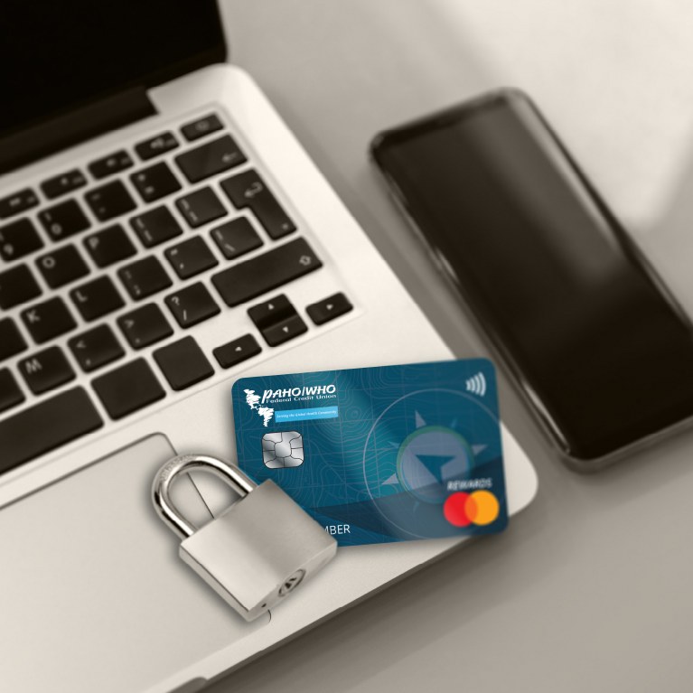 blue credit card over a computer with a flock next to a mobile phone