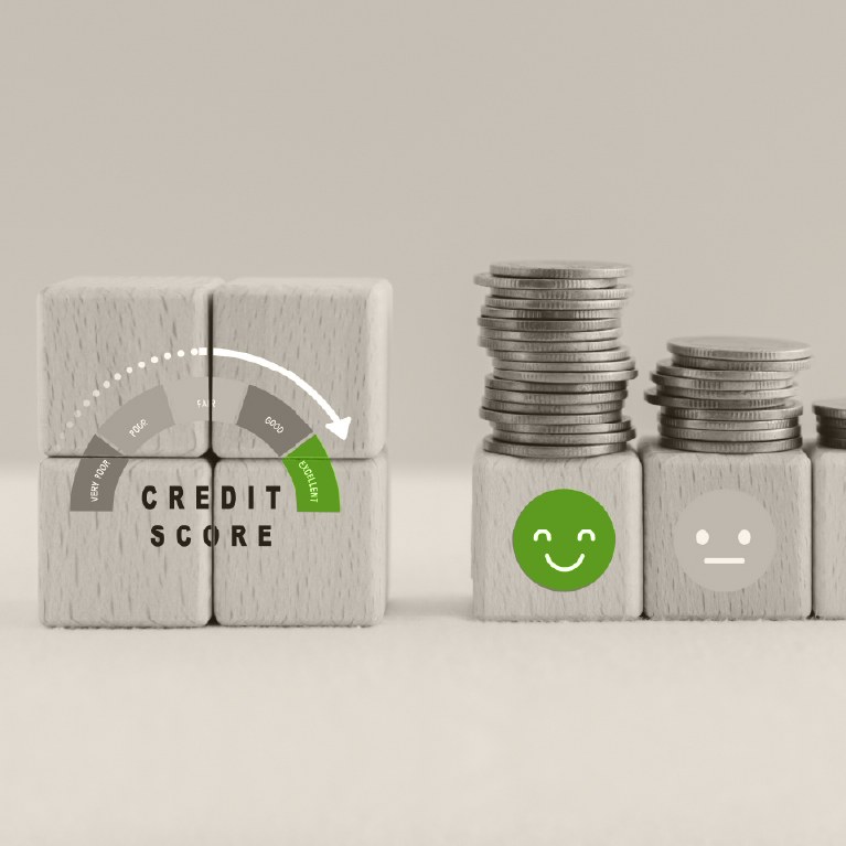 credit score gauge in green on wooden blocks