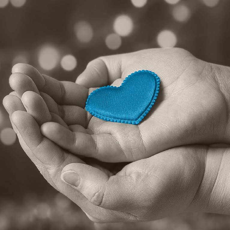 hand holding a blue heart