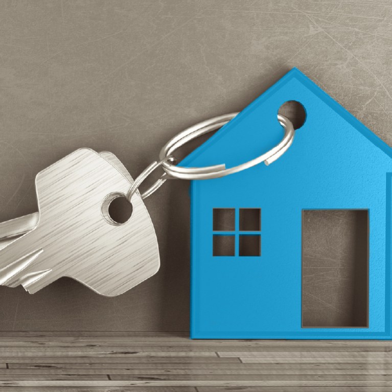 blue wooden house cutout with keys