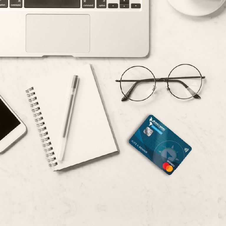 credit card next to phone and notepad