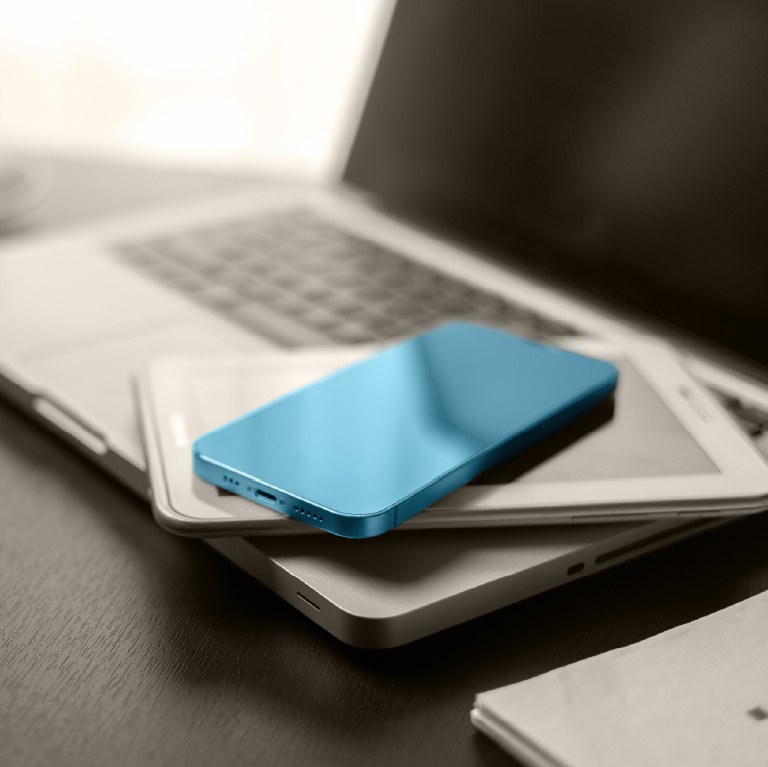laptop, smartphone, and tablet with money on it