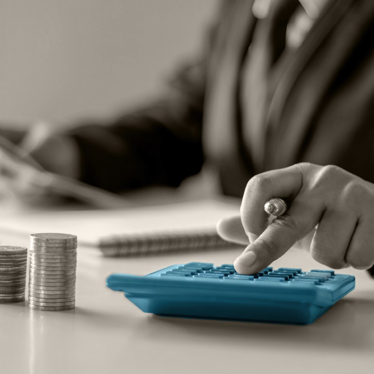 hand on teal calculator