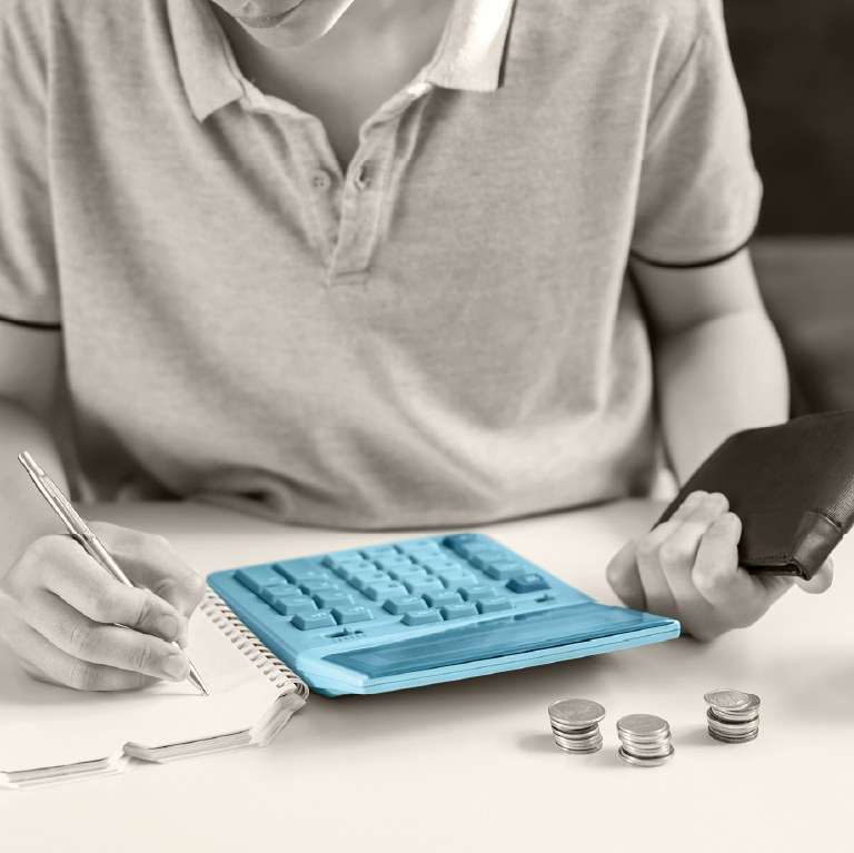 calculator, pens journal , wallet and money  on a table