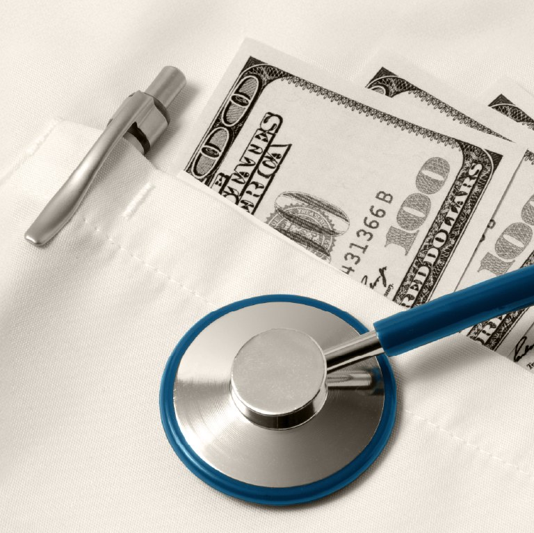 medical coat pocket with money and stethescope over it