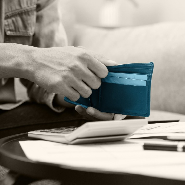 card in blue on a desk with laptop open