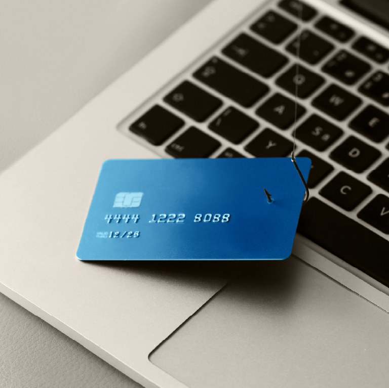 blue credit card on a laptop