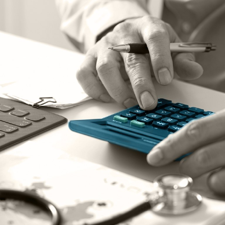 some one using laptop and blue calculator