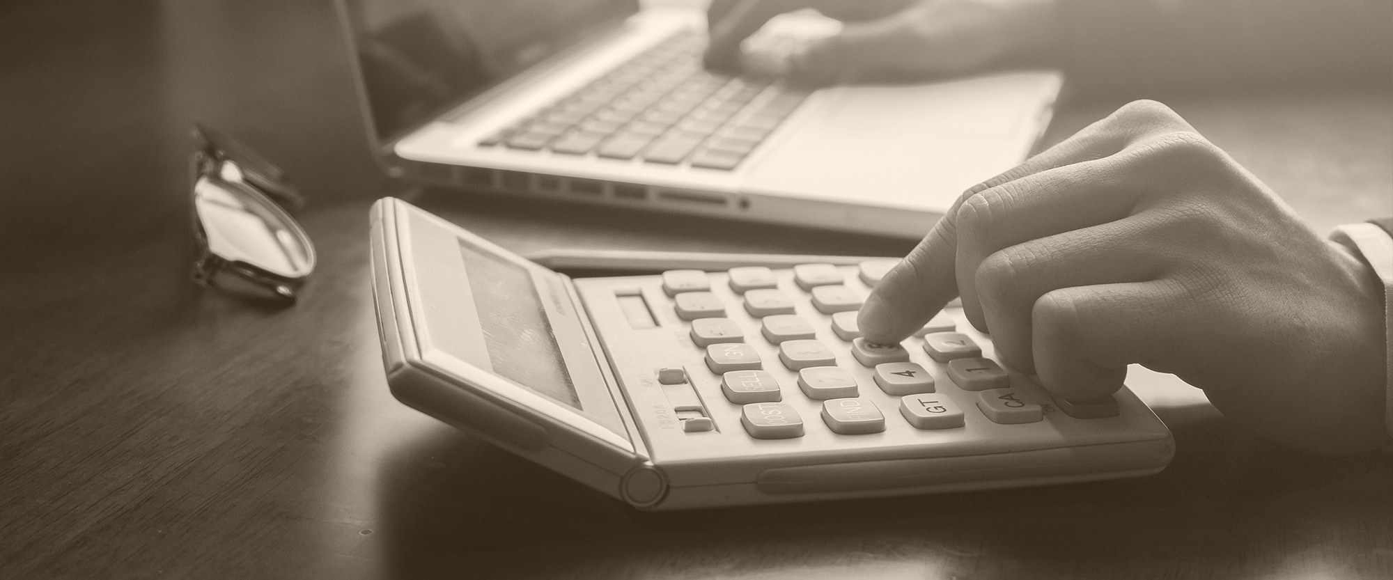 hand typing on a calculator