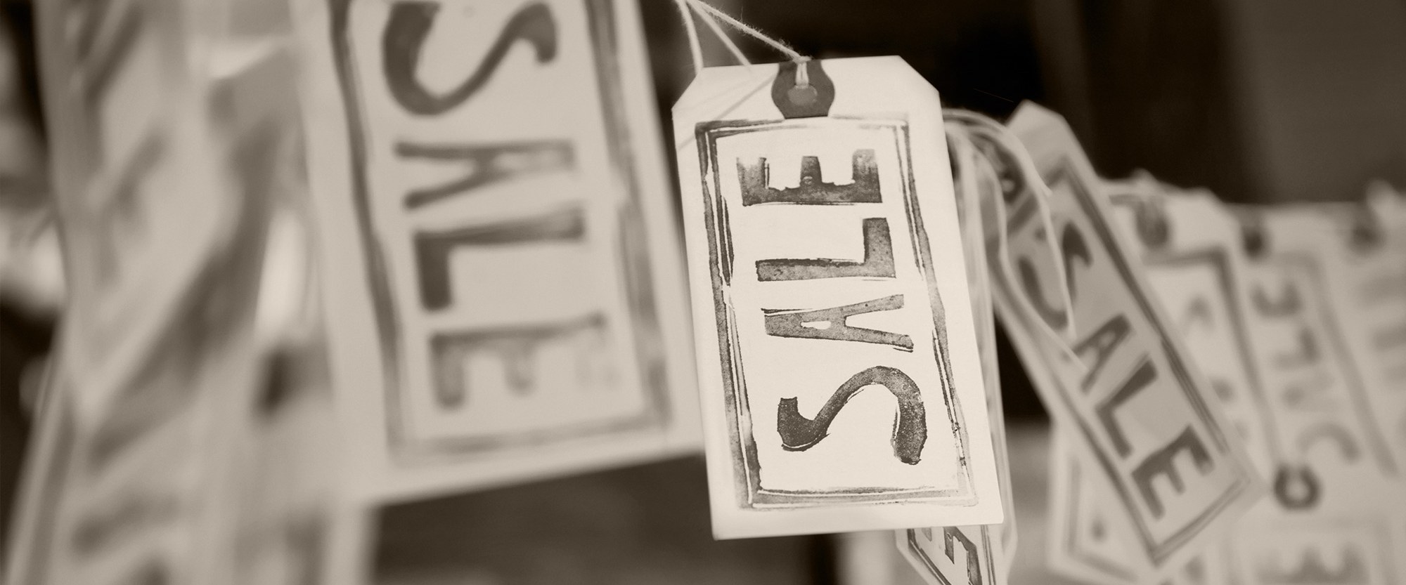 sale tags hanging on a string