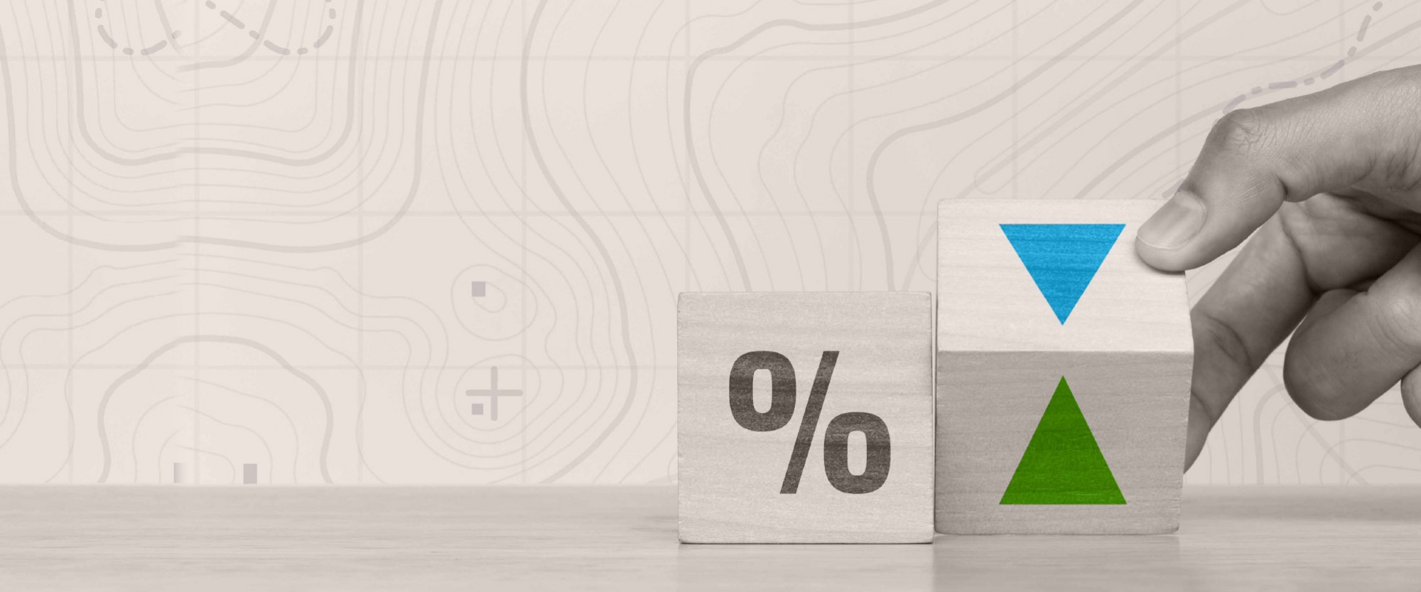 wooden blocks with percentage symbol and another wooden block with a green arrow pointing up or down
