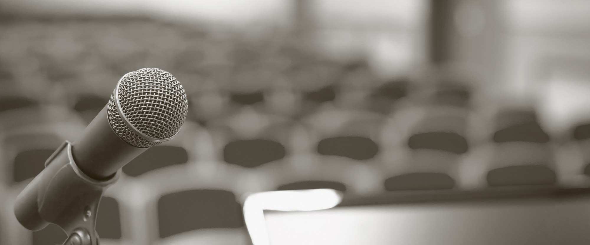 an open microphone in front of empty seats