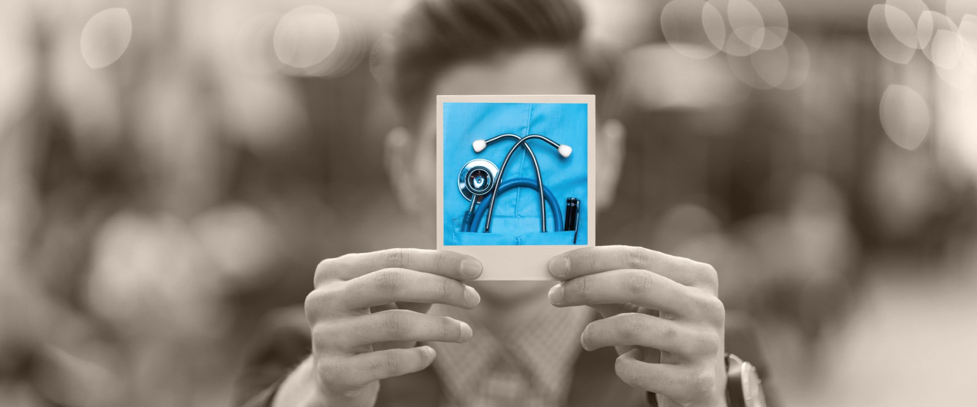 Person holding polaroid picture of stethoscope