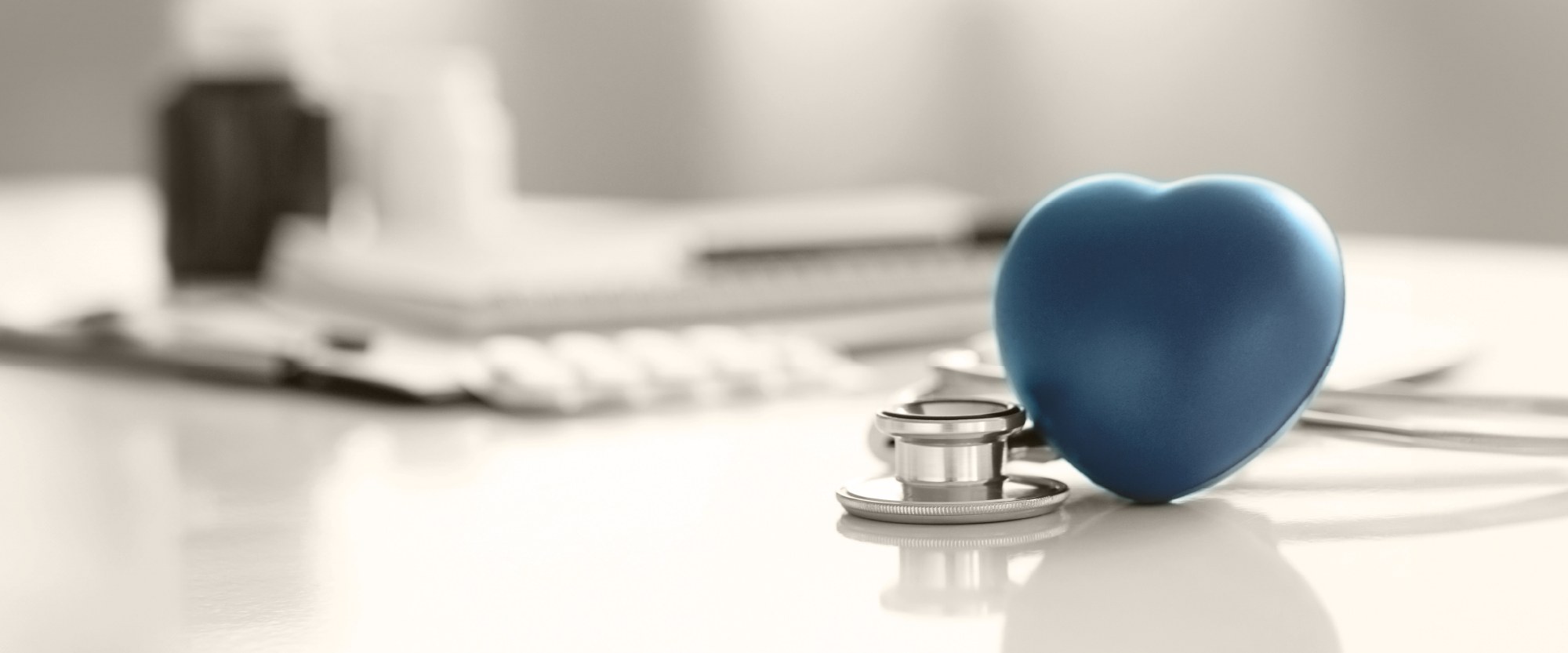 teal heart with stethoscope on top of a calendar