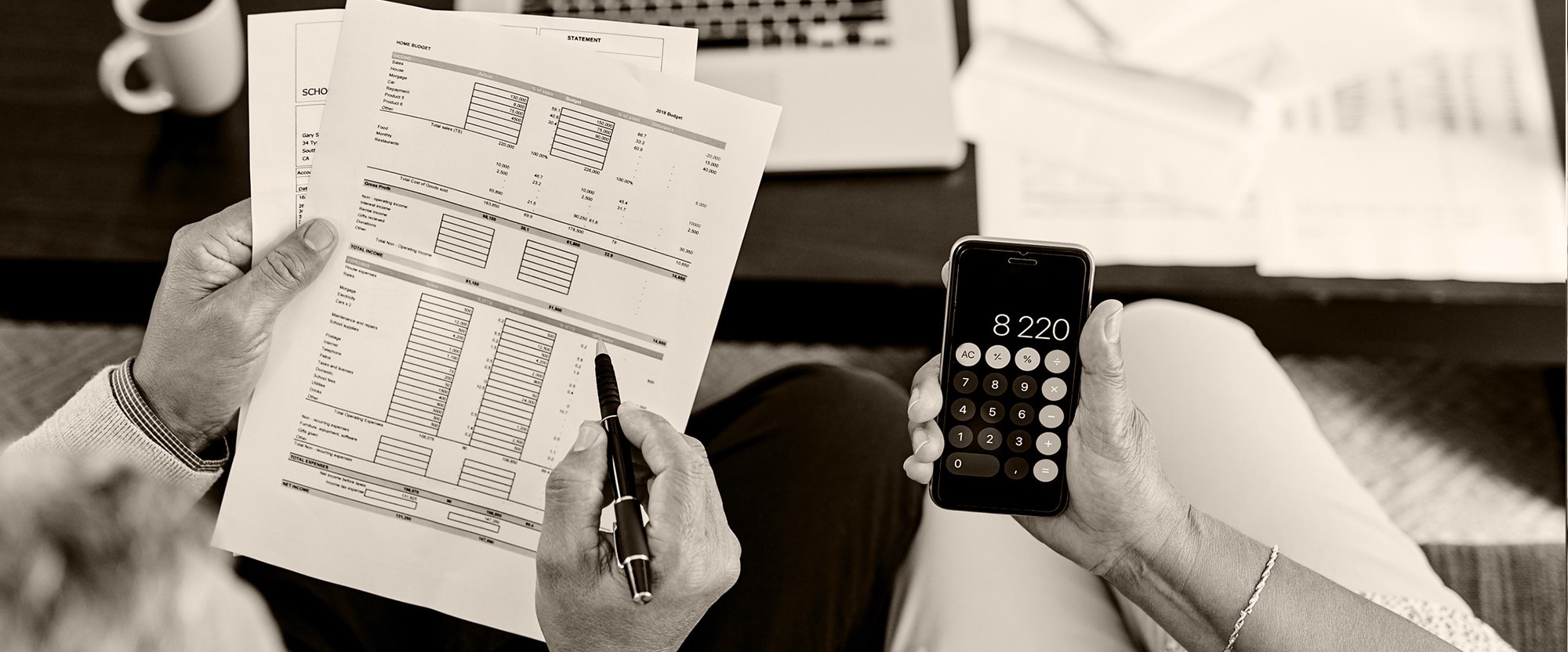 hands holding bills and a calculator