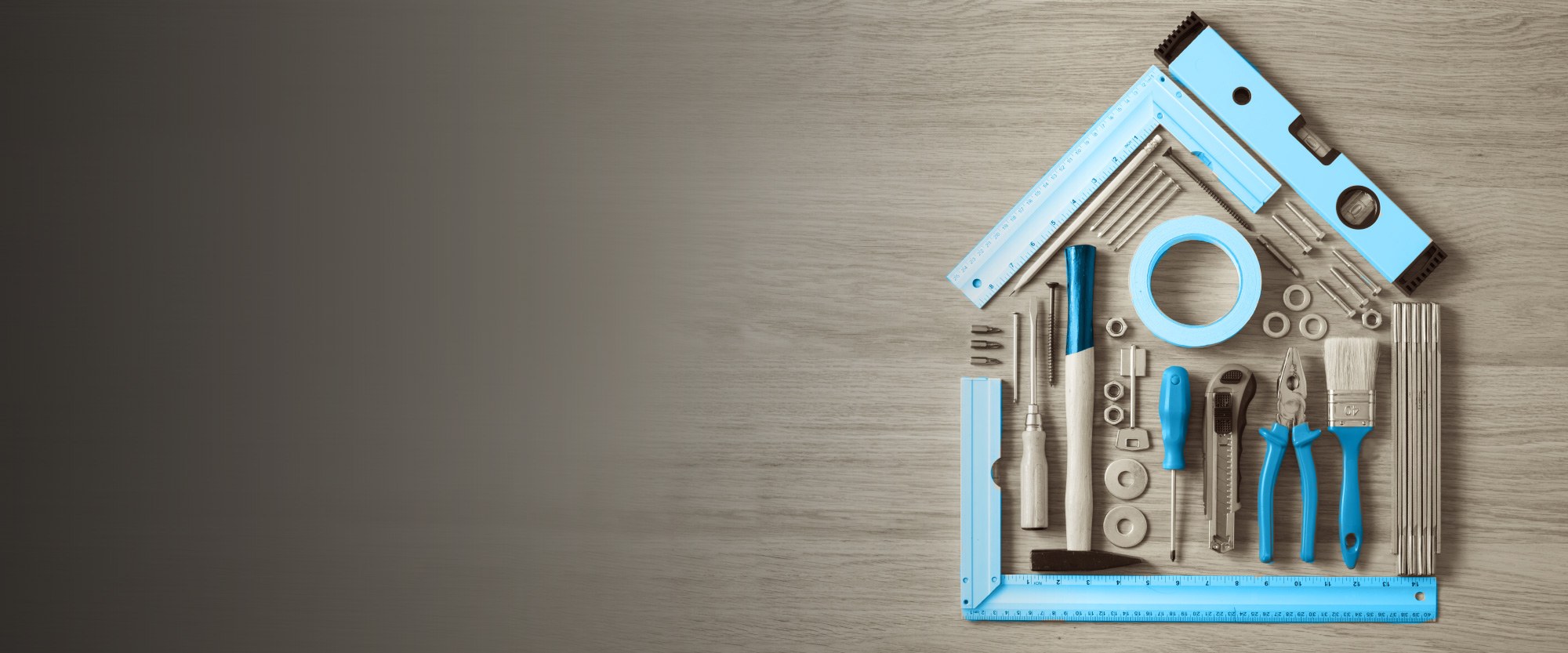 blue tools and paintbrushes that make the shape of a house