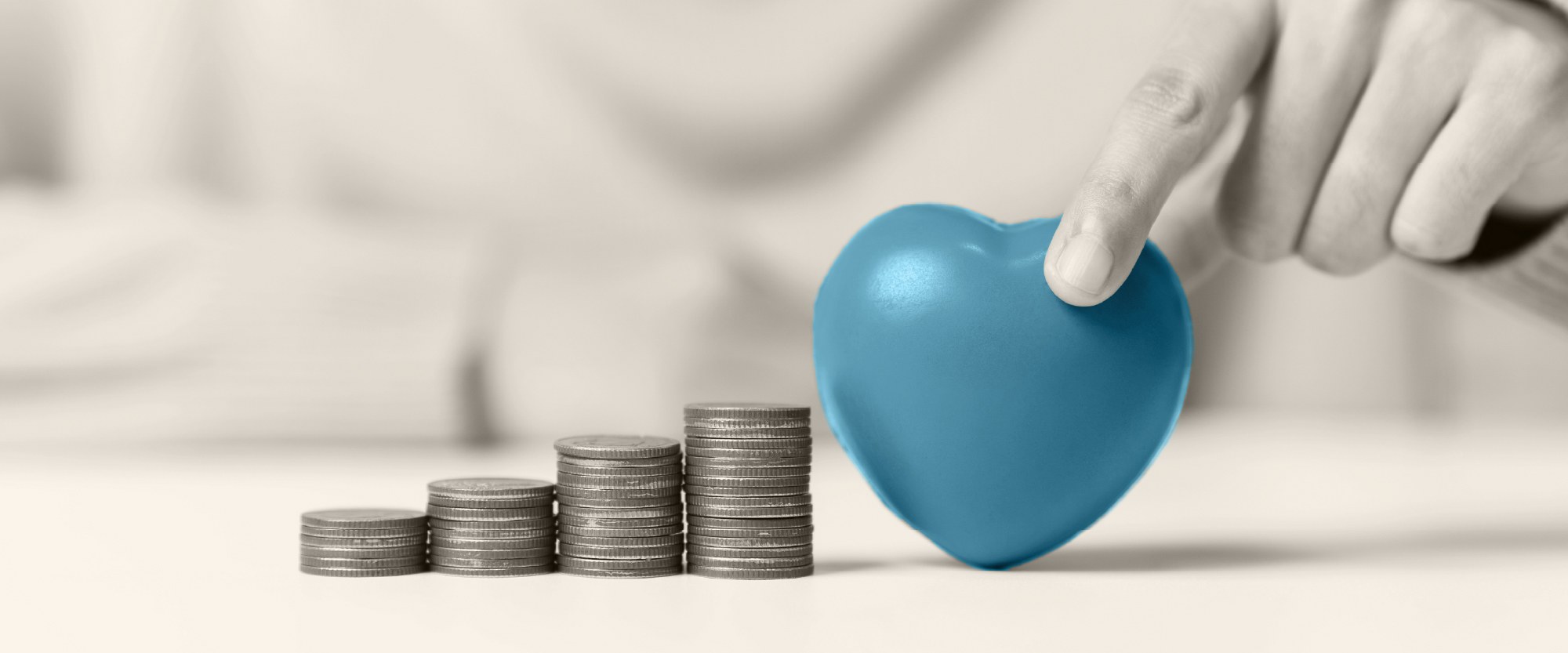heart next to stacks of coins