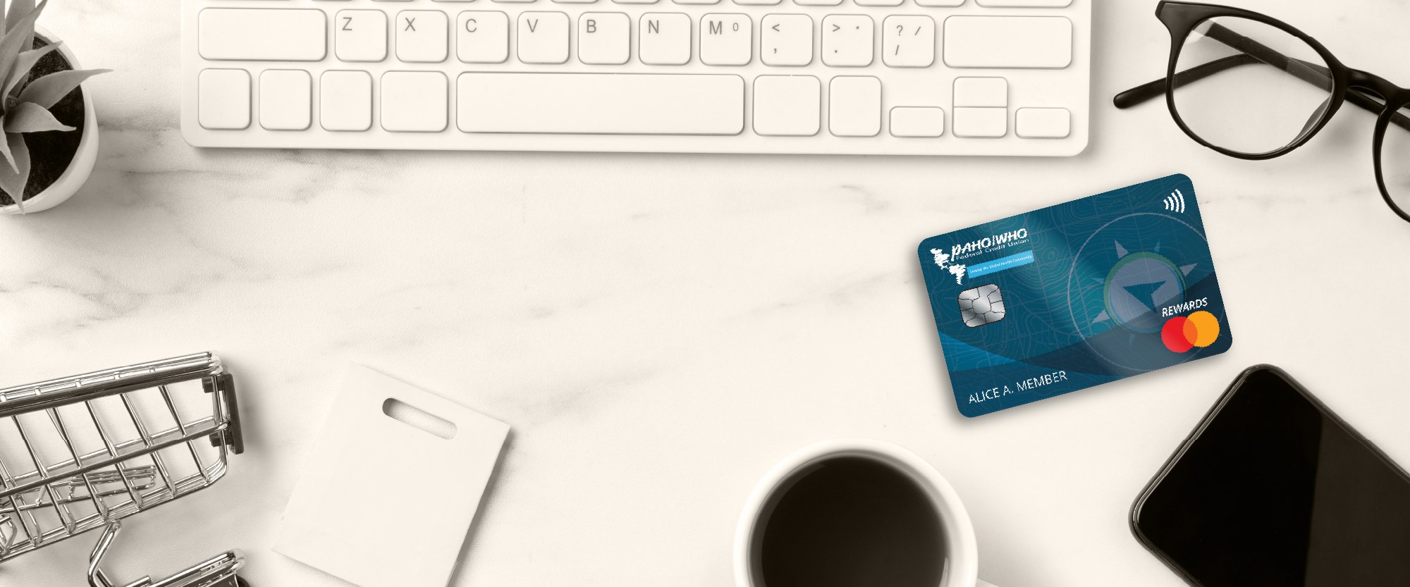 laptop glasses and a World rewards card on a desk