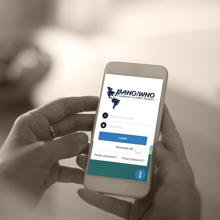Person logging into PAHO credit union account from mobile device