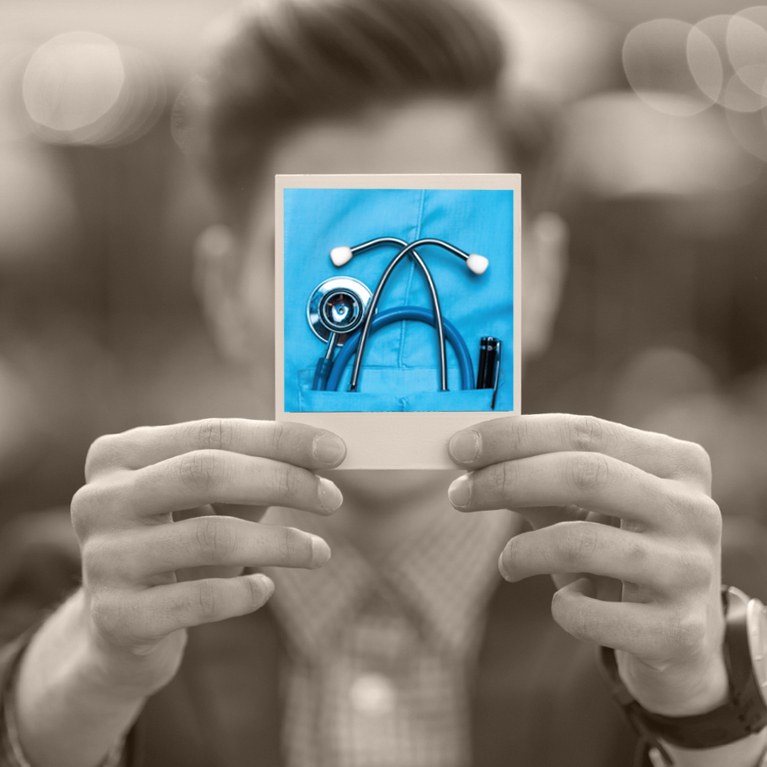 Person holding a polaroid photo of a stethoscope