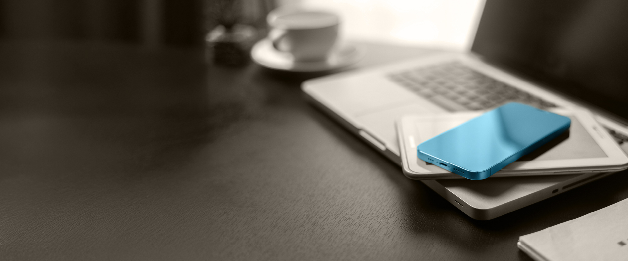 laptop, smartphone, and tablet with money on it