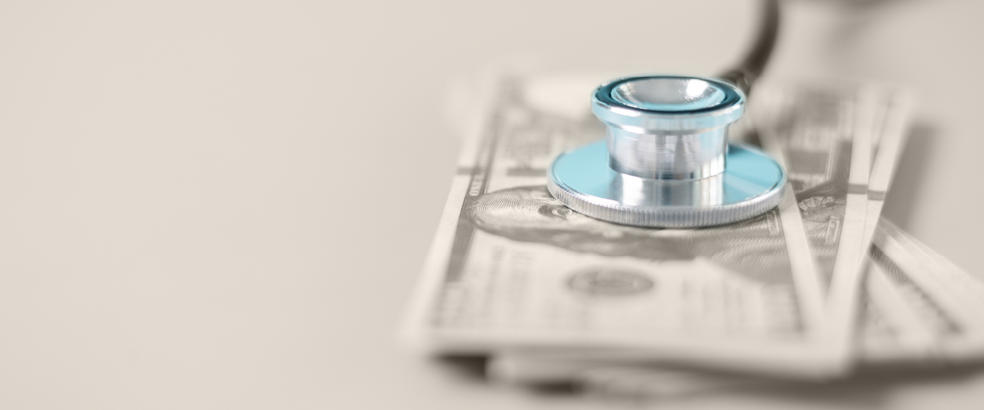 A blue STEthoscope over cash