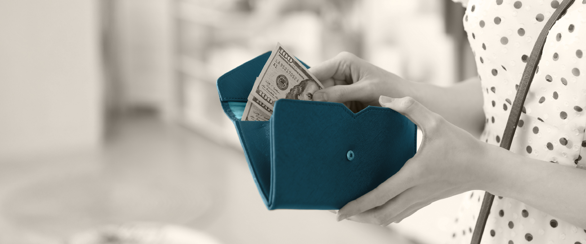 open wallet with hand inserting money