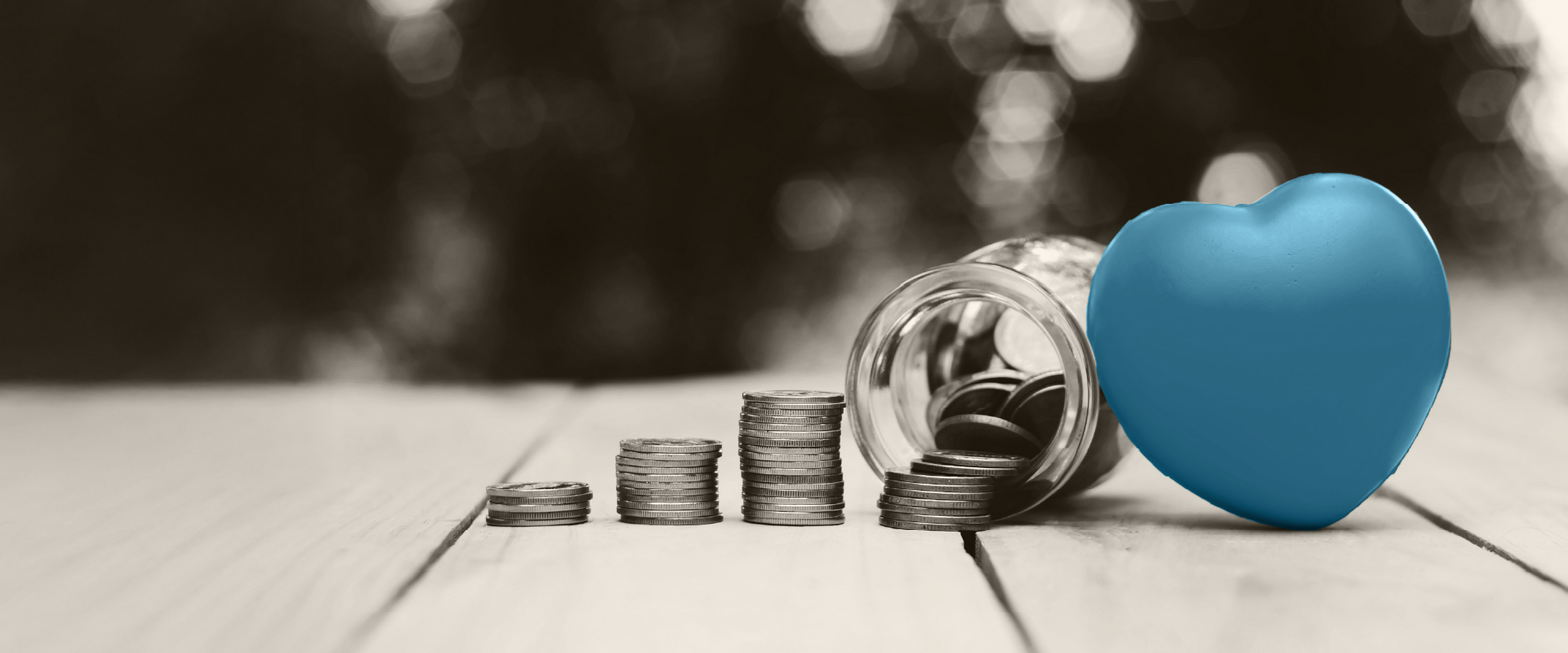 teal heart next to an overturned jar of coins