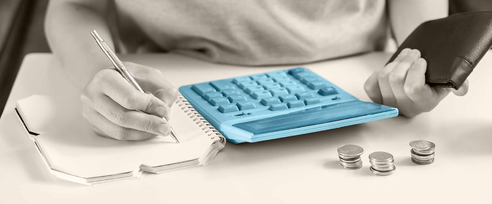 calculator, pens journal , wallet and money  on a table