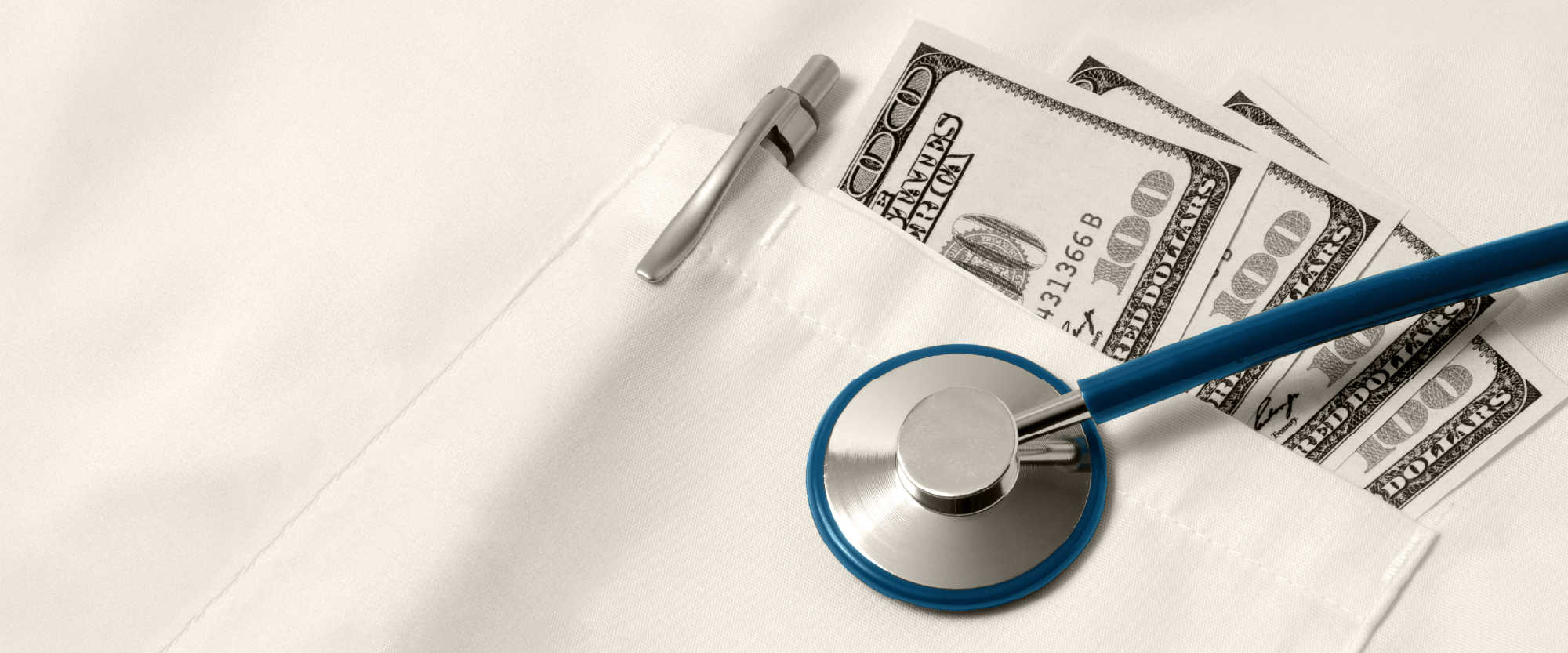 medical coat pocket with money and stethescope over it