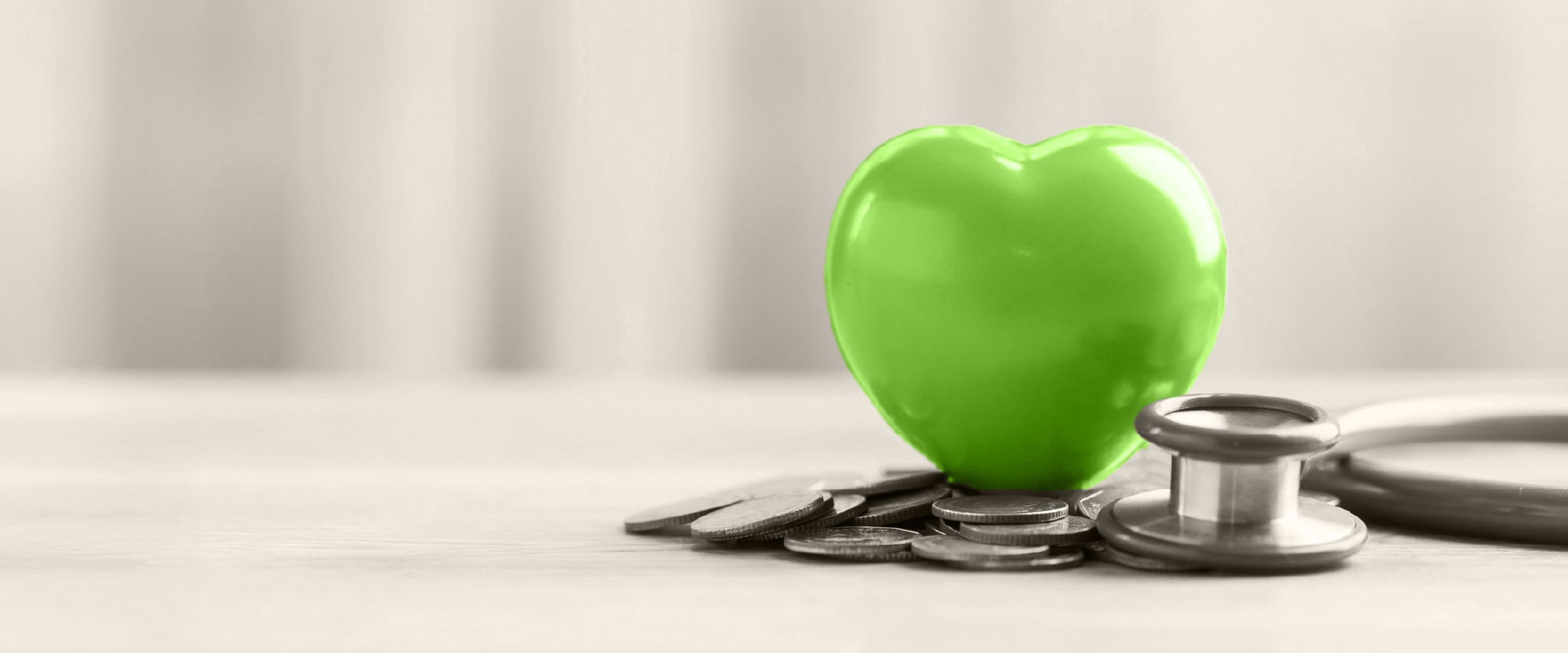 green heart over money and stethescope