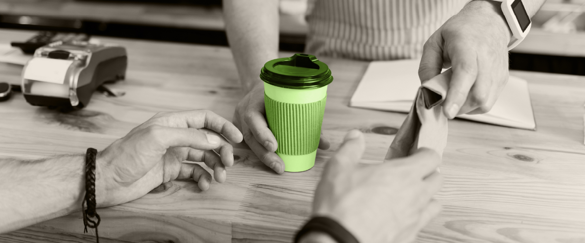 someone buying a cup of coffee at the counter