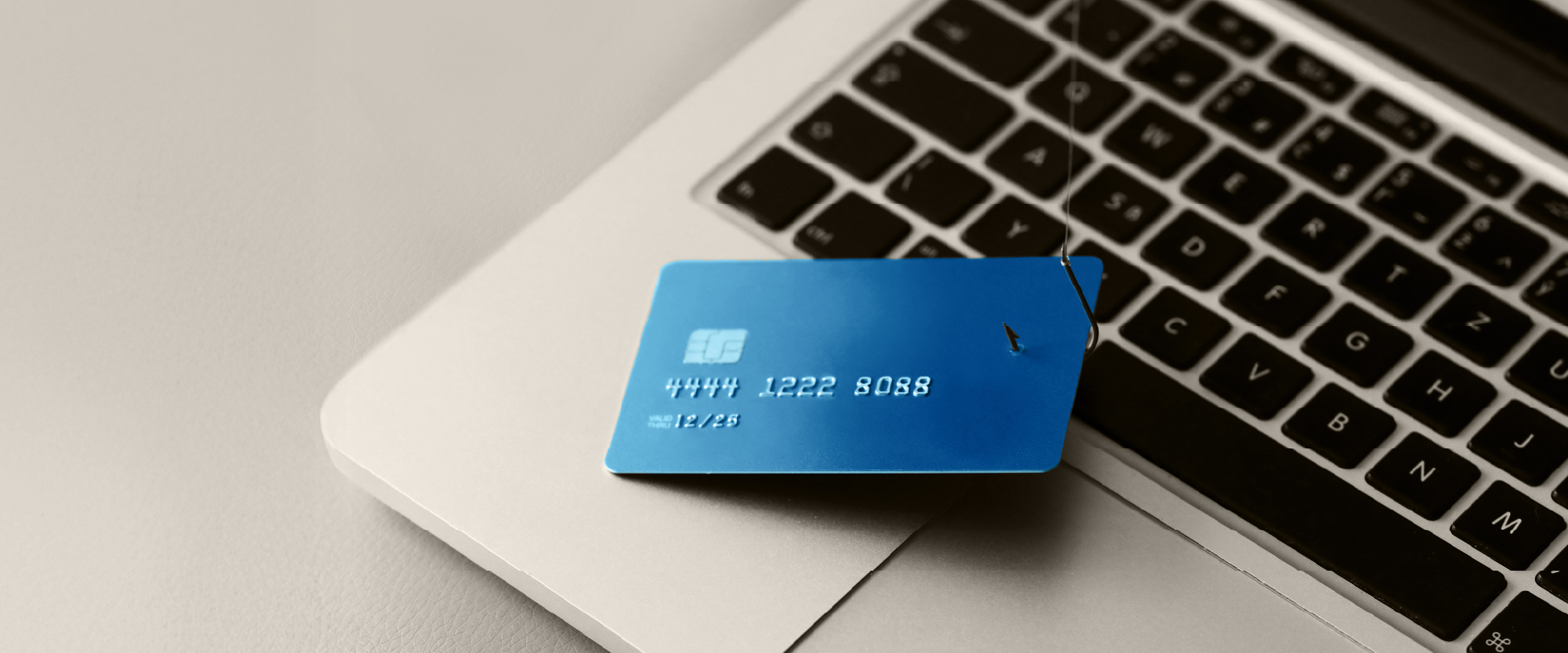 blue credit card on a laptop