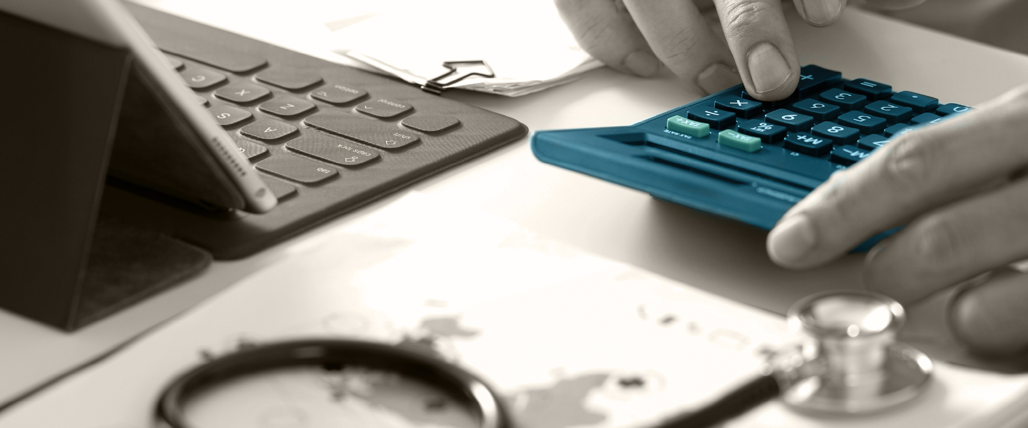 laptop, paper and blue calculator on table